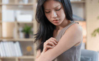 a girl is looking at her arm