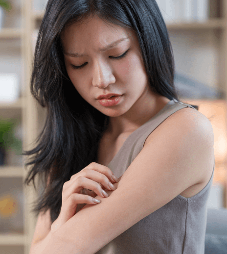 an asian girl holding her arm