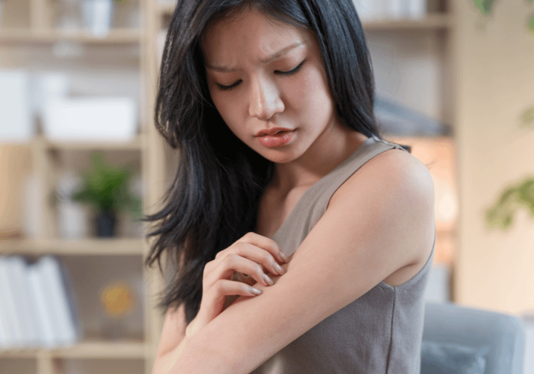a girl scratching his arm