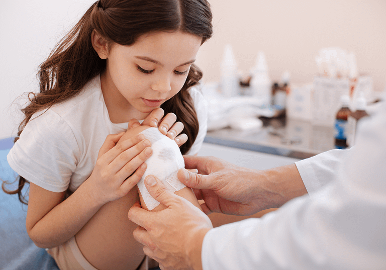 girl treating knee wound