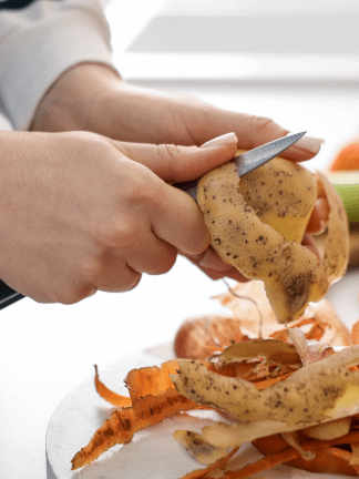 a hand cutting potatoes using a knife